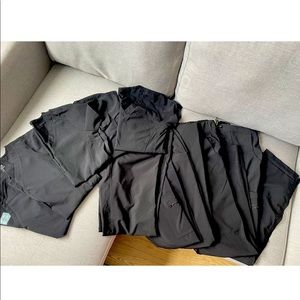 Five sets of black Medcouture scrubs